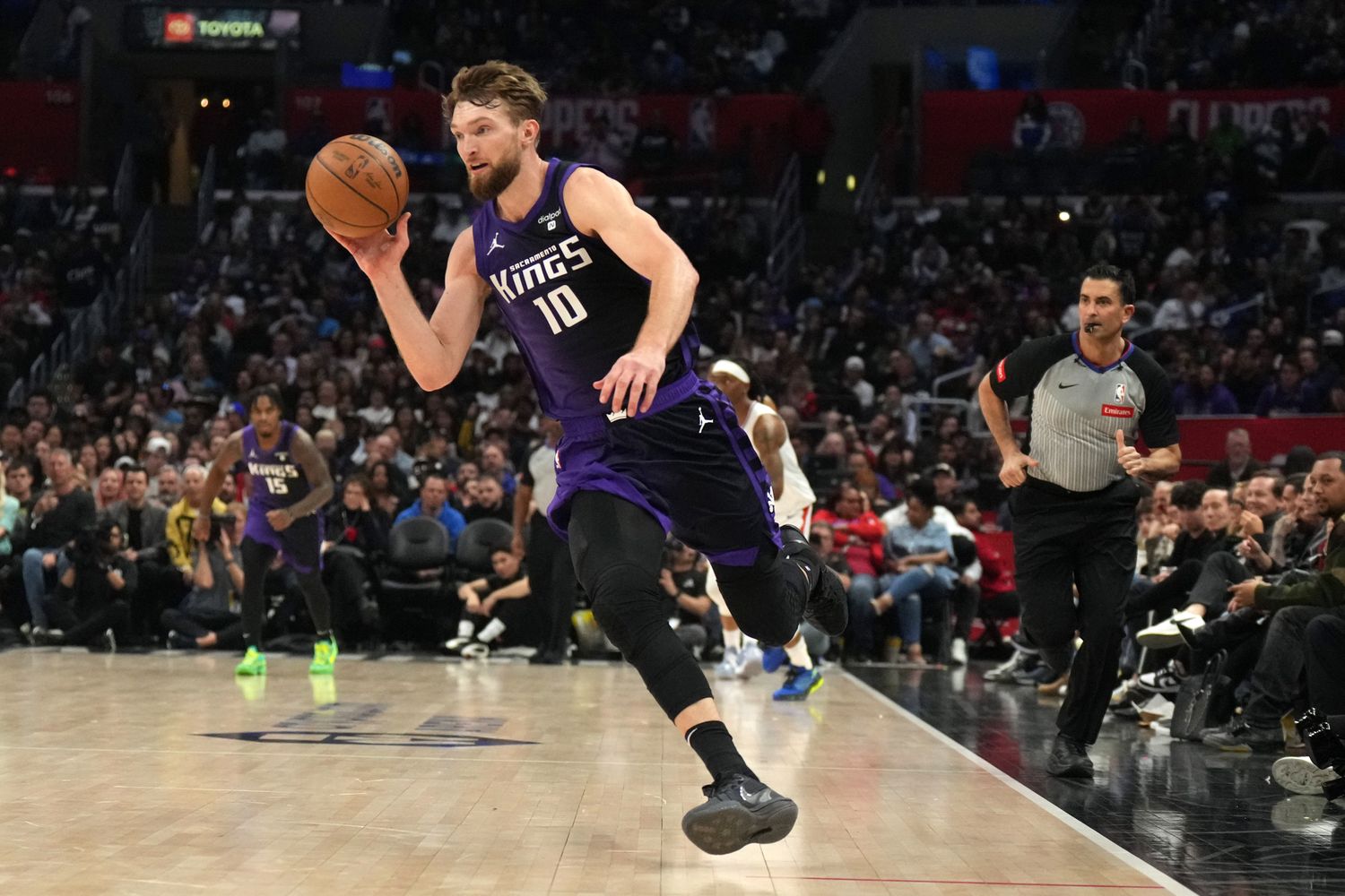 Feb 25, 2024; Los Angeles, California, USA; Sacramento Kings forward Domantas Sabonis (10) dribbles the ball against the LA Clippers in the second half at Crypto.com Arena. Mandatory Credit: Kirby Lee-USA TODAY Sports